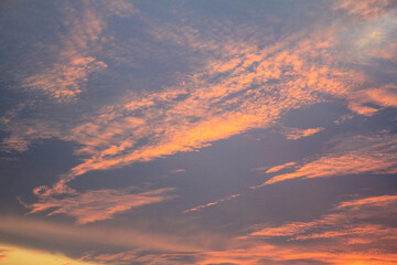 Sunset or sunrise. Dramatic majestic scenery sunset. Sky with clouds in sunset sky light background. Sunrise with clouds in various shapes. Calm sunset sky and sun through clouds over.
