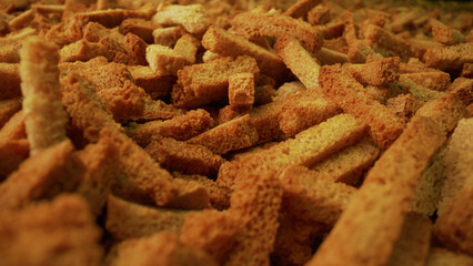 Delicious crunchy golden-brown rye croutons filling the frame, creating an appetizing food background
