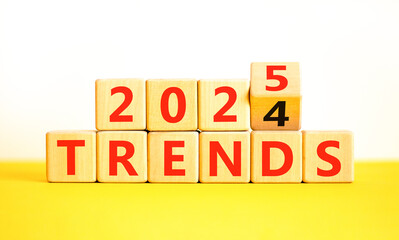 Planning 2025 trends new year symbol. Concept words 2024 Trends to 2025 Trends on beautiful wooden blocks. Beautiful yellow table white background. Business 2025 trends new year concept. Copy space.