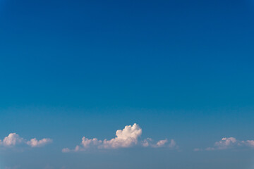 Clear blue sky, with a small strip of white clouds