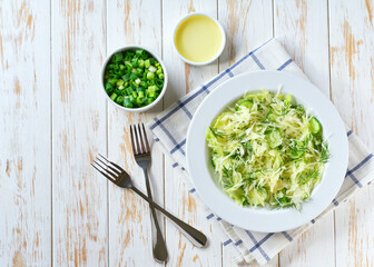 Spring vegan salad with cabbage, cucumber and dill. Top view, flat lay, overhead.