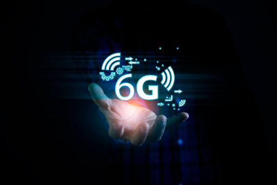 6G Technology networks Internet connecting wireless devices around the world. 6g icon in businessman hand. 6G technology is essential to businesses in the digital world.. - Powered by Adobe