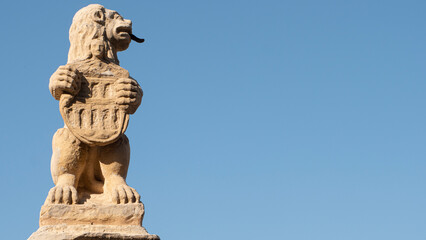 Stone lion sculpture with heraldic shield in the city of Segovia (Spain)