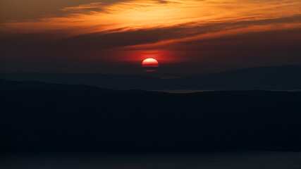 Hazy sunset over the Croatian Adriatic islands Krk and Cres.
