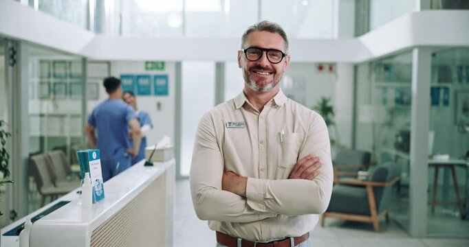Mature, business man and arms crossed at clinic for leadership in healthcare admin or patient care. Hospital director, employer and portrait with smile in medical center for compliance and management