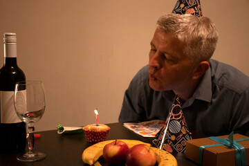 Mid aged man celebrating alone. People