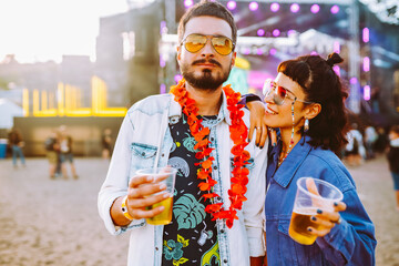 Couple with beer at music festival. Summer Beach party, holiday, vacation concept.