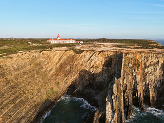 Aerial view of the Farol do Cabo Sardão lighthouse at the edge of the steep cliff. in Portugal