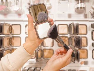 choice of cosmetics. palette of powder and foundation.choosing powder and makeup brush