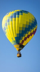 Fototapeta premium A colorful hot air balloon floats against a clear blue sky. (1)
