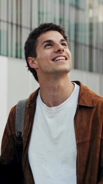 Young man going to the office workplace building, walking happy with ideas and inspiration