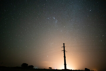High voltage power line in a nocturnal landscape, La Pampa, Patagonia, Argentina.