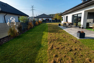 Scarifying the lawn before the winter season using an electric scarifier.