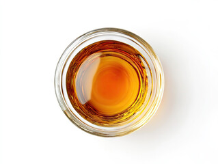Overhead photograph of organic maple syrup in a glass
