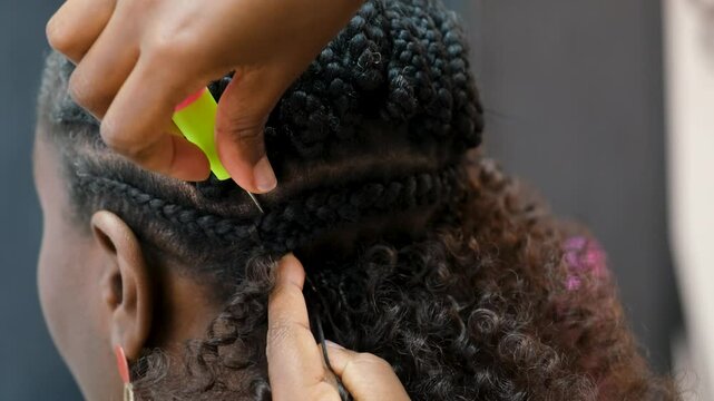 Hairdresser is making crochet braids to a customer in a hair salon
