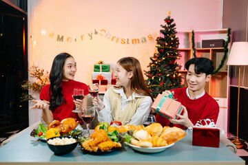 Holiday spirit with Asian friends exchanging gifts, sharing laughs, and enjoying a festive Christmas dinner