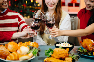 Holiday spirit with Asian friends exchanging gifts, sharing laughs, and enjoying a festive Christmas dinner