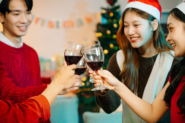 Asian friends capture the holiday spirit with gifts, laughter, and a festive Christmas dinner in a cozy, joy-filled setting