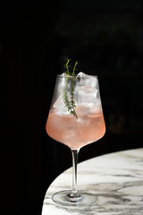 Mediterranean Spritz Cocktail with sweet vermouth, wine, thyme prosecco and ice cubes