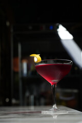 Manhattan cocktail glass on a marble table background with copy space, close-up