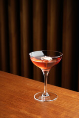 Cocktail with peach liqueur, wine and vanilla flower petals.