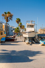 Traditional colorful fishing boats Luzzu in the Harbor of Mediterranean fishing village Marsaxlokk at sunny day, Malta.