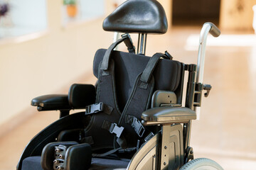 Modern Ergonomic Wheelchair with Supportive Restraints in a Bright Indoor Environment