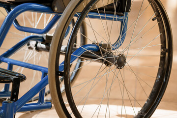 Close-up View of a Blue Wheelchair Wheel and Spokes