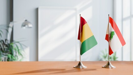 FLAGS OF GUINEA And LEBANON ON TABLE