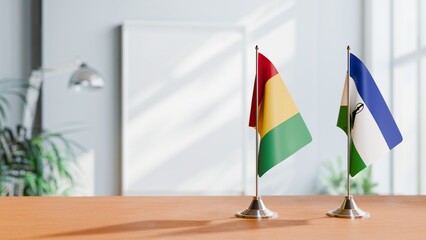 FLAGS OF GUINEA And LESOTHO ON TABLE