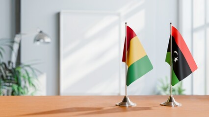 FLAGS OF GUINEA And LIBYA ON TABLE