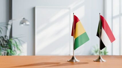 FLAGS OF GUINEA And SUDAN ON TABLE