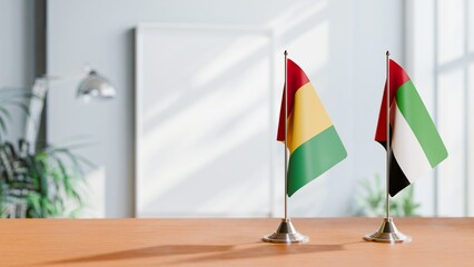 FLAGS OF GUINEA And UAE ON TABLE