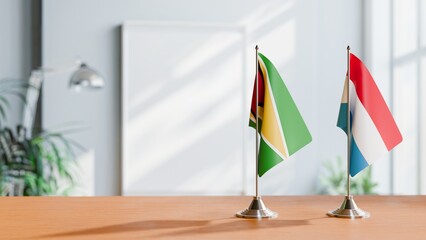 FLAGS OF GUYANA And LUXEMBOURG ON TABLE