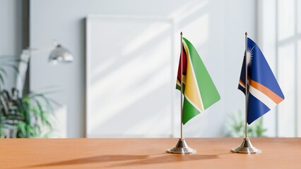 FLAGS OF GUYANA And MARSHALL ISLANDS ON TABLE