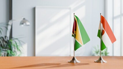 FLAGS OF GUYANA And NIGER ON TABLE