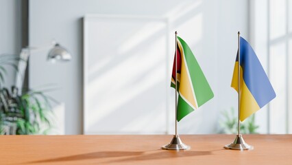 FLAGS OF GUYANA And UKRAINE ON TABLE