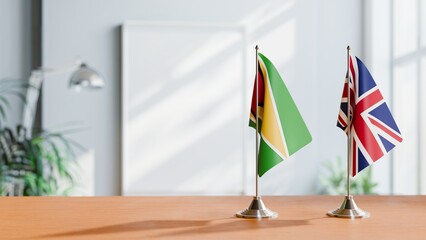 FLAGS OF GUYANA And UNITED KINGDOM ON TABLE