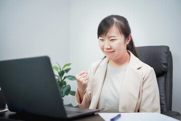 Asian businesswoman is happy while working
