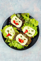 A group of sandwiches with Halloween decorations.