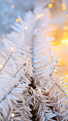 close- a white artificial tree branch with warm lights