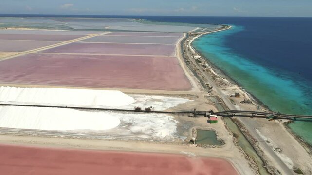 aerial view of the Salt mountains and pans where sea water is evaporated and the salt stay's behind, also the loading dock is visible  in the scene 