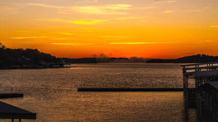Fototapeta premium Sunrise over the marina at the Lake of the Ozarks with a dramatic cloudscape in Missouri, USA