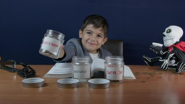 A child in businesswear makes greedy face expression and hands gesture.Empties coins from investment jar into swear jar. High quality 4k footage