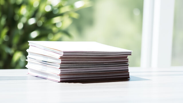 stack white paper brochures on a table