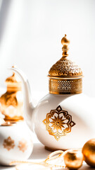 white teapot with golden accents intricate designs