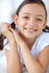 Carpet, confidence or portrait of girl in home for joy, growth and fun on weekend in living room of house. Smile, face or healthy female kid alone for happiness, satisfaction or childhood in Spain