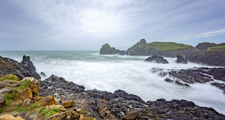 Long exposure photograph of scenic Kynance Cove on the Lizard Peninsula on a stormy day in Cornwall, UK