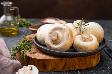  Fresh raw champignon mushrooms on gray background close up