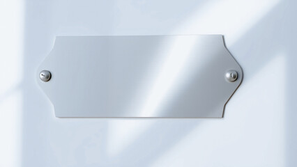 blank silver nameplate mounted on a white wall